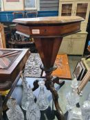 A Victorian trumpet sewing table having chequer board lid