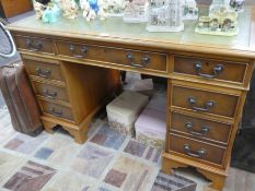 A reproduction Yew wood twin pedestal desk having 9 drawers