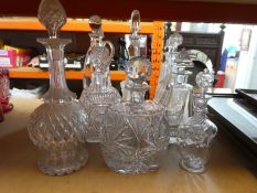 12 various decanters, some being cut crystal