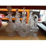 12 various decanters, some being cut crystal