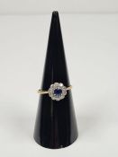 18ct white gold sapphire and diamond cluster ring with central round cut sapphire approx 0.25 carat