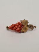 Vintage silver gilt and coral brooch in the form of a bunch of grapes, marked 800, 5.5cm
