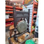 An early 20th Century, standing gong on carved wooden stand decorated acorns and oak leaves