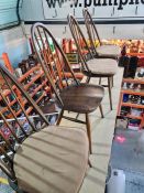 A set of 4 Ercol stickback dining chairs of dark colour