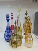 A German green glass decanter having gilt decoration, other Bohemian coloured glass decanters and su