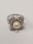 14K white gold diamond and pearl cocktail ring with central pearl with twisted diamond set frame, ma