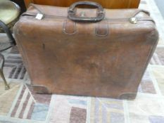An old leather tan suitcase with combination lock