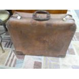 An old leather tan suitcase with combination lock