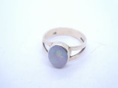 9ct yellow gold dress ring with split shoulders leading to oval cabouchon opal, rubover set, marked