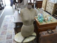 A dress making dummy by Singer, and an oval coffee table having Onyx top