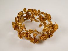 Attractive 18ct yellow gold unusual bracelet in the form of Rose heads and trailing leaves, 3cm wide
