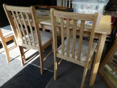 A modern oblong dining table and 4 matching chairs