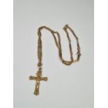 A 9ct gold neckchain of twisted design, hung with a 9ct gold crucifix both marked 375, 5.69g approx