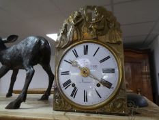 An old French Farmhouse wall clock having enamelled dial with decorative brass surround