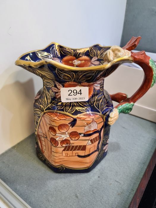 An antique 19th Century, Masonic jug with hydra handle, the body deep blue and decorated flowers and