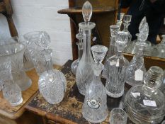 12 various glass decanters, some having engraved decoration