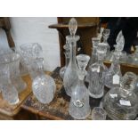 12 various glass decanters, some having engraved decoration