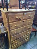A modern pine chest having two short and five long drawers