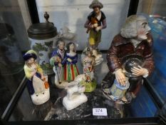 An antique Toby Jug in form of seated man with lantern, Staffordshire figures and sundry
