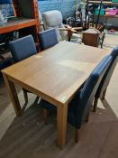 A modern oak effect dining table with a set of four chairs