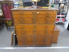 An early 20th Century plan chest in three parts, 12 drawers in pitch pine and pine handles stamped G