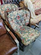A pair of Ercol style stickback armchairs with loose cushions