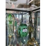 A Victorian green glass dump paperweight, and two other items of glass ware