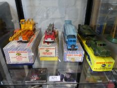 Four vintage Dinky die cast vehicles to include car transporter and tank transporter, all boxed