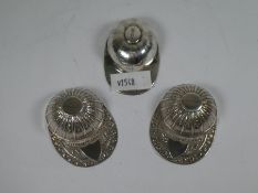 Of Racing Interest; a pair of novelty silver Jockey Cap caddy spoons. The cap and peak are embossed