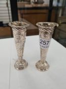 A pair of miniature Victorian silver vases having gadrooned feet and embossed floreated body. Hallma