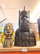 An African carved bust of tribal man and a brass bust of man with open mouth