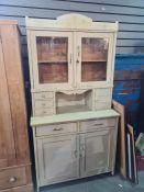 A painted pine kitchen dresser having glazed back