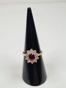 18ct yellow gold ruby and diamond cluster ring with central oval faceted ruby, approx 1 carat, surro