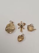 9ct oval locket with engraved plant decoration, 9ct heart charm, 9ct kettle charm, and 9ct sapphire