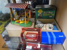 A German tinplate clockwork fairground ride, battery cat, Dinky 362 Starfigther and others