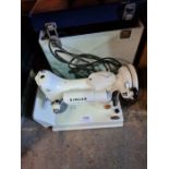 A circa 1960s - Singer electric sewing machine model 221K, in fitted case
