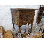 A small oak cupboard having carved panels