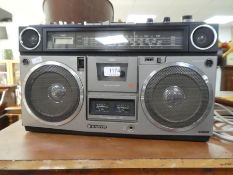 A Snayo portable cassette radio model M9990L, an one other Sony Earth Orbitor radio