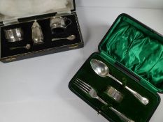 A silver cruet set comprising of a salt shaker, two salts, one having a hinged lid and handle, and t