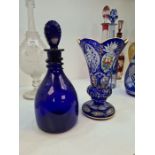 A bohemian blue and clear glass vase having painted floral panels and a Bristol blue glass decanter