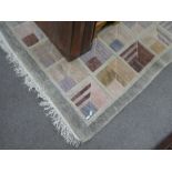 A modern woollen rug having design of geometric squares, 290cm x 247cm