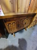 A reproduction continental style cupboard, the front carved King and soldiers