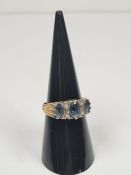 9ct gold dress ring set with 3 oval faceted pale blue sapphires, separated with diamond chips, marke