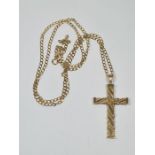 A 9ct yellow gold curb link necklace 60cm, marked 375, hung with a large 9ct yellow gold cross penda