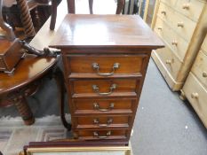 A reproduction pillar chest having 7 drawers and a box base dressing mirror