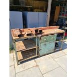 A vintage large wood and metal Industrial work bench