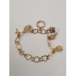 9ct yellow gold charm bracelet comprising of heart shaped links, hung 6 charms, one unmarked, 6 9ct