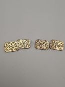 Pair of 9ct yellow gold rectangular cufflinks with tapered corners and floral engraving, marked 375,