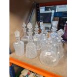 A selection of cut glass decanters, one being in the form of Thistle
