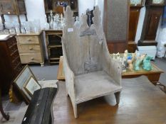 An antique French child's chair having shaped top with crude repairs